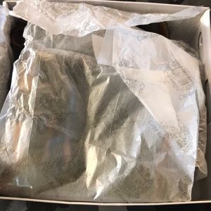 Thigh high open toe heeled boots.